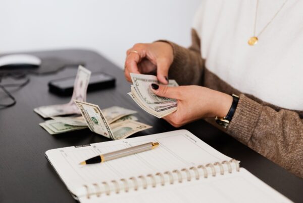 Woman handling bonus money at a desk