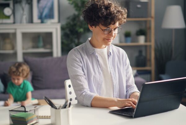 Woman at computer, child in background