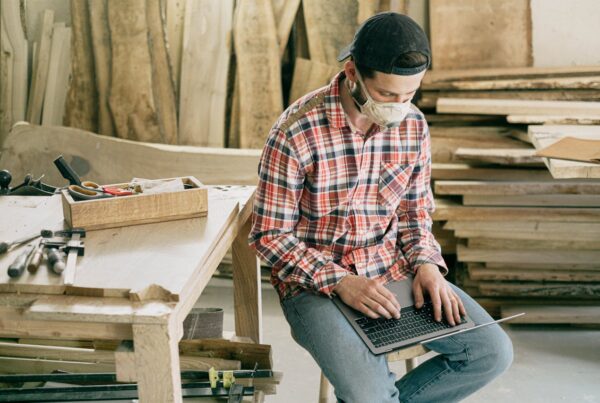 A woodworker sitting in shop planning retirement