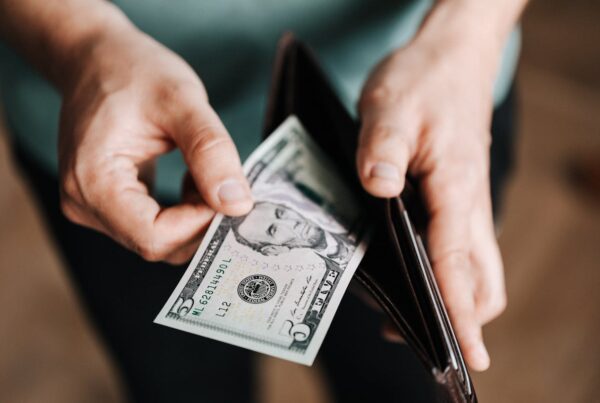 Taking a $5 bill out of a wallet