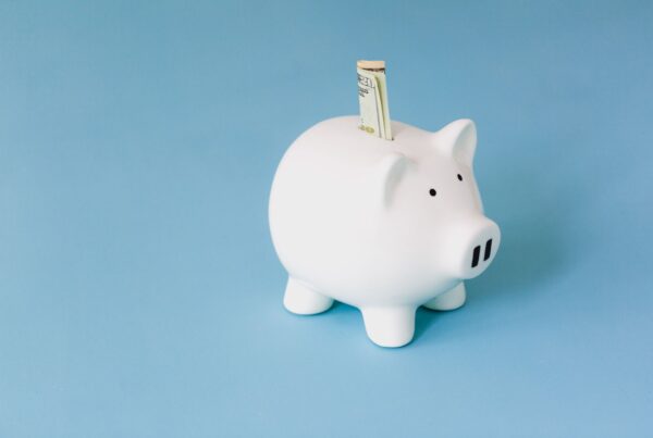 $20 bill sticking out of a piggy bank