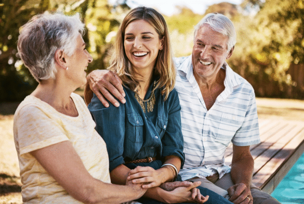 Adult daughter sitting with parents discussing estate planning with adult children
